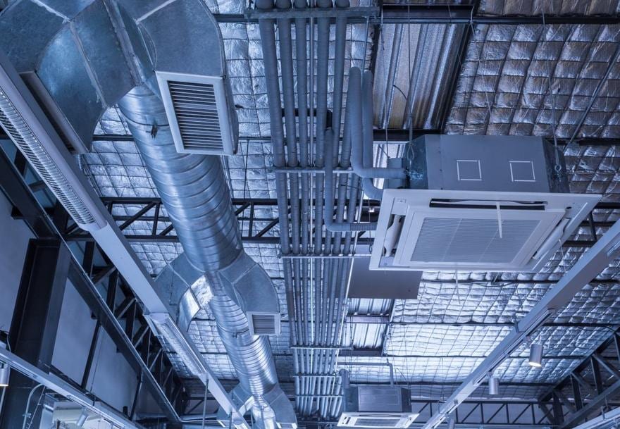 Exposed spiral ductwork and structural steel in a building interior
