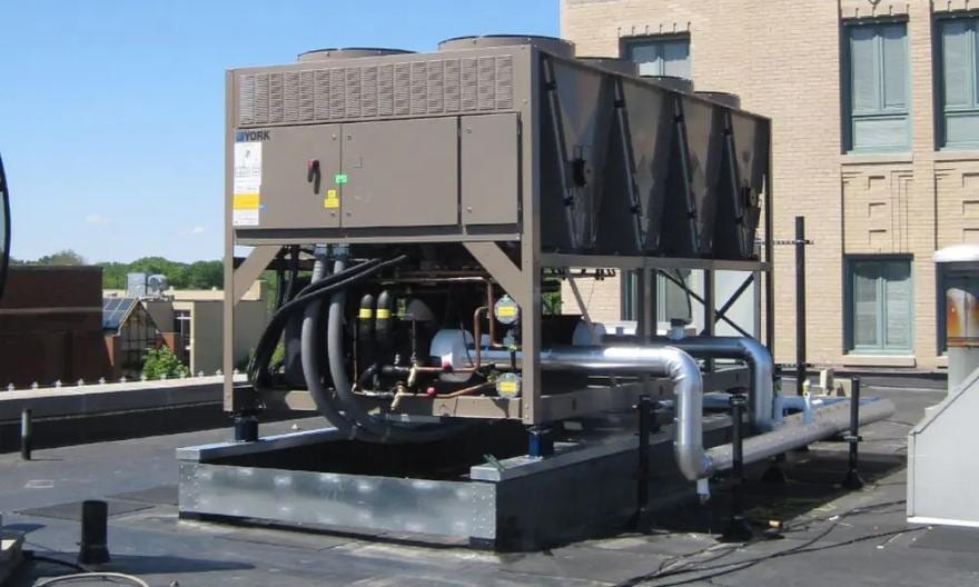Air-cooled chiller with insulated chilled-water piping on a rooftop