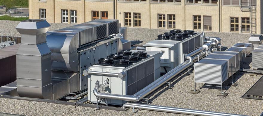 Rooftop air handlers and ductwork on an institutional building